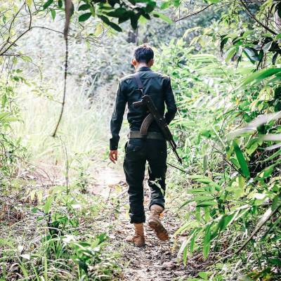 a man standing next to a tree