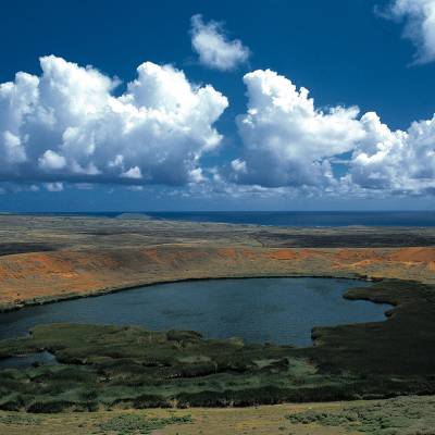 a body of water with a mountain in the background