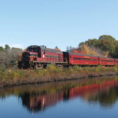 a train crossing a bridge over a body of water