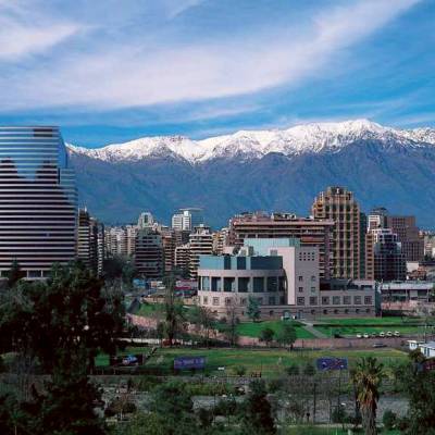 a large building with a mountain in the background
