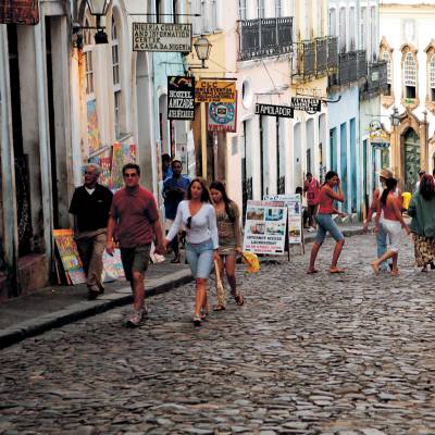 a group of people walking on a sidewalk