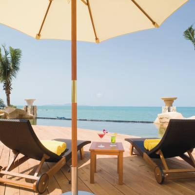 an umbrella sitting on top of a wooden chair