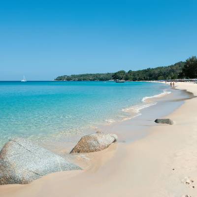 a sandy beach next to a body of water