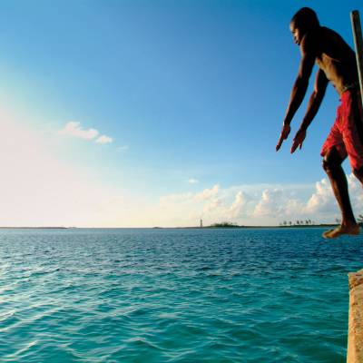 a man standing next to a body of water