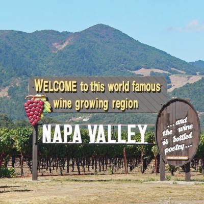 a sign with a mountain in the background