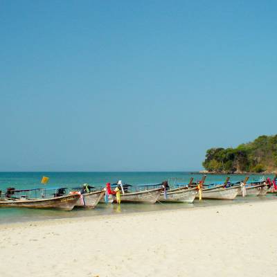 a group of people sitting at a beach