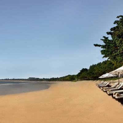 a sandy beach next to a body of water