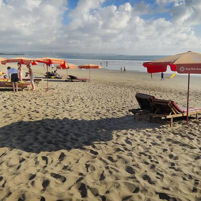 an umbrella sitting on top of a sandy beach