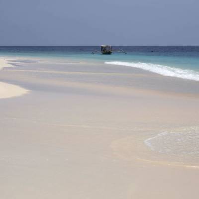 a sandy beach next to the ocean