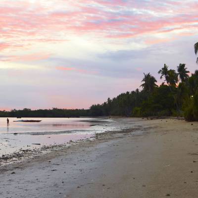 a sandy beach next to the water