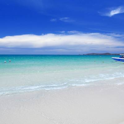 a sandy beach next to the ocean