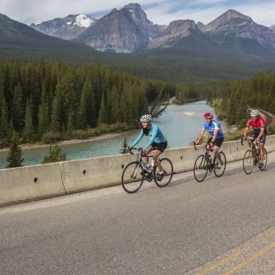 a man riding a bicycle on the side of a mountain road