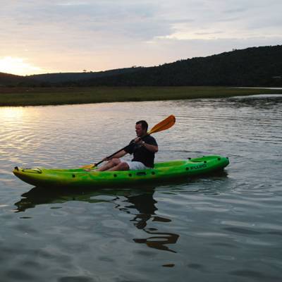 a person in a green boat on a body of water