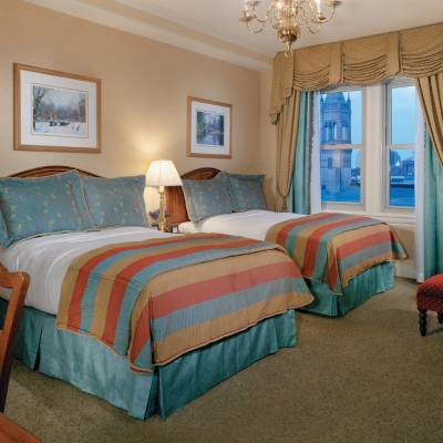 a bedroom with a bed and a chair in a room