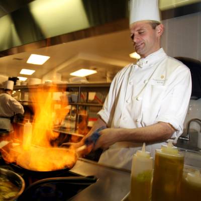 a man cooking in a kitchen preparing food