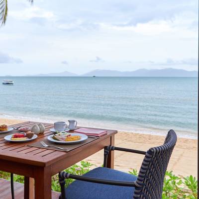 a chair sitting in front of a body of water