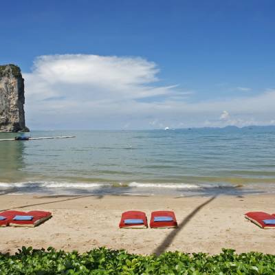 a group of people sitting at a beach