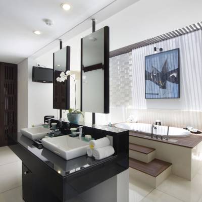 a white sink sitting under a mirror next to a window