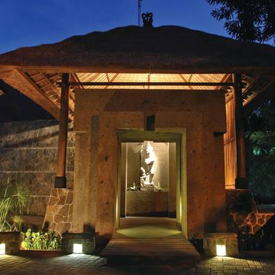 a view of a stone building with a mountain in the background