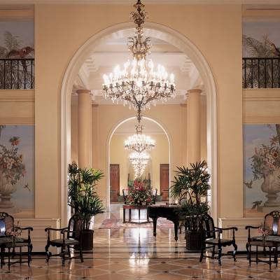 a room filled with furniture and vase of flowers on a table