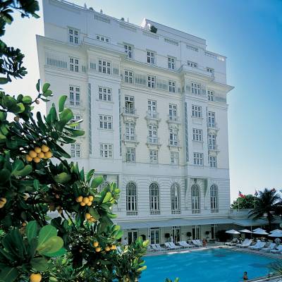 a group of palm trees and a building