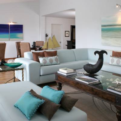 a living room with a couch a table and looking at the camera
