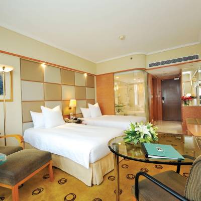 a bedroom with a bed and desk in a room