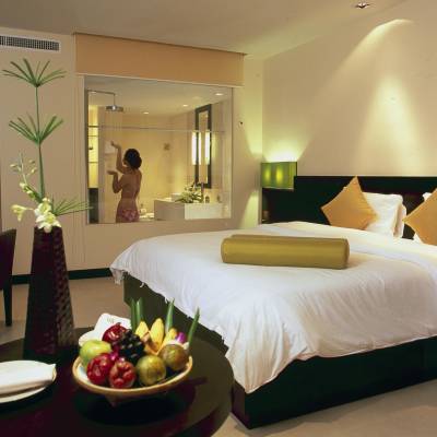 a bedroom with a bed and a table in a room