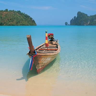 a person sitting in a boat on a body of water