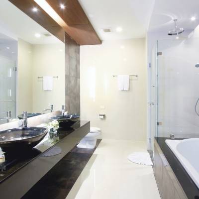 a large commercial kitchen with a sink and a mirror