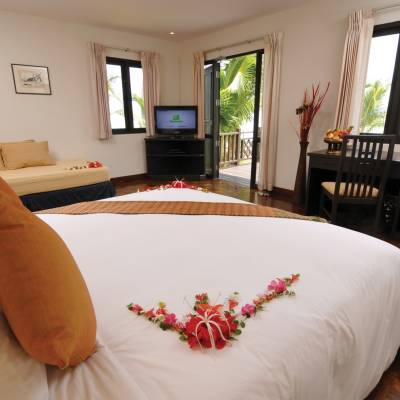a bedroom with a large bed in a hotel room