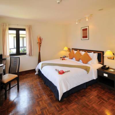 a bedroom with a bed in a room