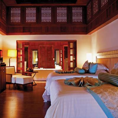 a bedroom with a bed and desk in a room