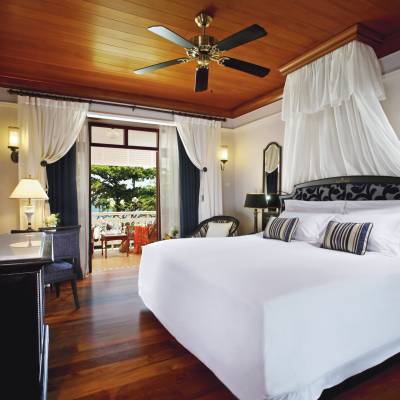 a bedroom with a bed and desk in a room