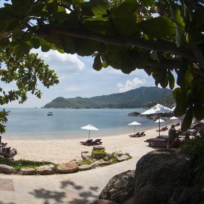 a sandy beach next to a body of water