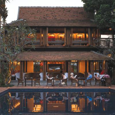 a group of people performing on stage in front of a building