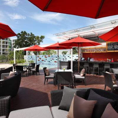 a dining table with a red umbrella