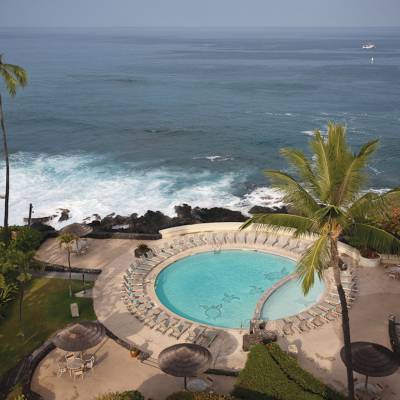 a beach with palm trees and a body of water