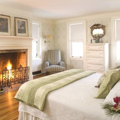 a bedroom with a bed and a fireplace