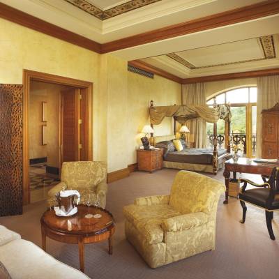 a bedroom with a bed and a chair in a room