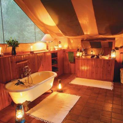 a large white tub next to a sink