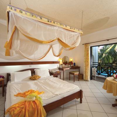a bedroom with a bed and a mirror