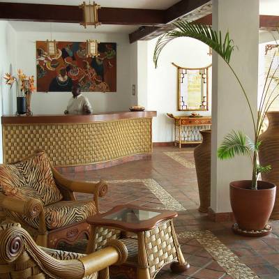 a living room filled with furniture and vase of flowers on a table