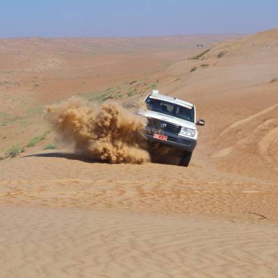 a truck driving down a dirt road