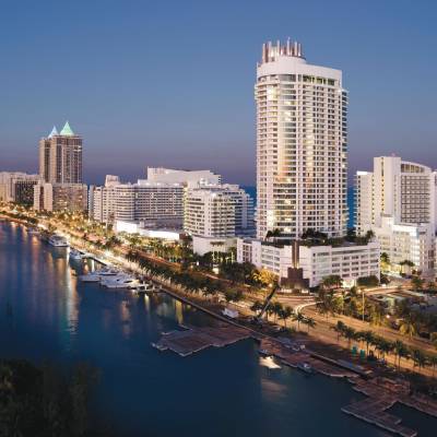 a body of water with a city in the background