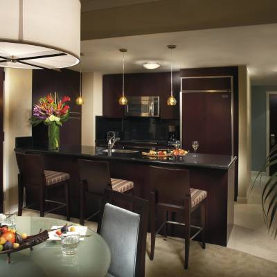 a room filled with furniture and vase of flowers on a table