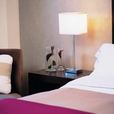 a large white bed in a hotel room