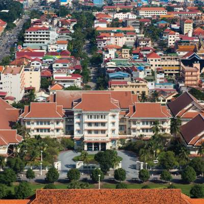 a large building with a mountain in the background