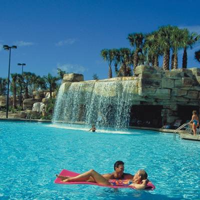 a group of people swimming in a pool of water
