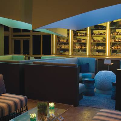 a person sitting at a table in front of a store